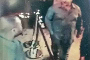 A surveillance video still that purportedly shows the police officer, right, who cold-cocked a man at Tonic East in September 2013.